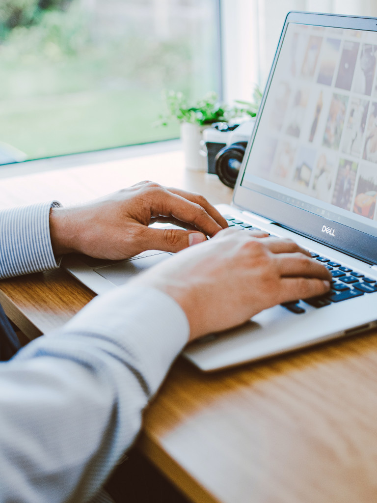 hands typing on laptop